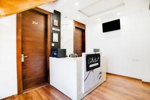a lobby with a door and a sign on a counter at Collection O Mall Road Nainital Formerly Urban Bliss in Nainital