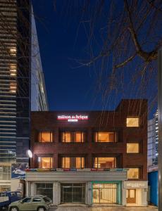 a building with a sign on the front of it at 메종드브릭 호텔 in Seoul