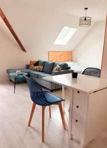 a living room with a couch and a table and chairs at Birdie H N21 ST2 in Giez