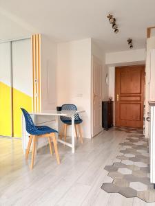 a living room with a table and two chairs at Birdie H N21 ST2 in Giez +17 photos