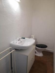 a bathroom with a white sink and a toilet at Maison proche centre Les Vans in Les Vans