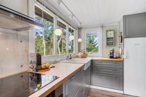 a kitchen with a sink and a refrigerator at Trekanthytte in Moss