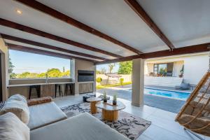 a living room with a couch and a hammock at Khaya Elihle Guest House in Hazyview