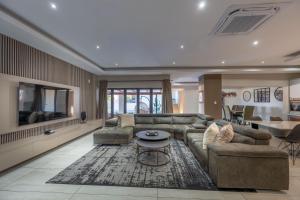 a living room with a couch and a table at Khaya Elihle Guest House in Hazyview