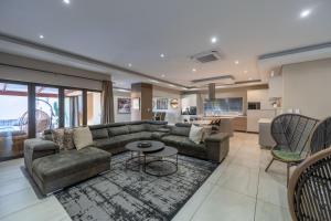 a living room with a couch and a table at Khaya Elihle Guest House in Hazyview