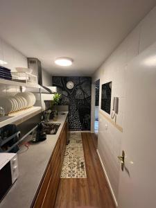 a kitchen with a sink and a stove in a room at Casa Micho in Tomares
