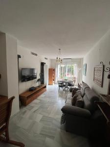 a living room with a couch and a table at Casa Micho in Tomares