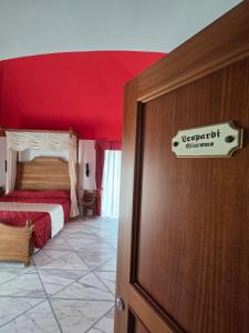 a bedroom with a bed with a red ceiling at Antico Casale Russo in Piano di Sorrento