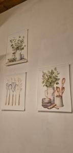 three framed pictures of flowers and plates on a wall at Il Castello di Monteggiori in Camaiore +97 photos
