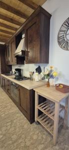 a kitchen with wooden cabinets and a wooden table at Il Castello di Monteggiori in Camaiore