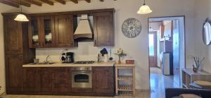 a kitchen with wooden cabinets and a stove at Il Castello di Monteggiori in Camaiore