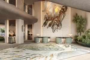 a lobby with three tables and a painting on the wall at Icona's Costa Ragusa Resort - New Opening in Scoglitti +71 photos