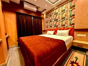 a bedroom with a large bed in a room at Bengal Guest House in Howrah