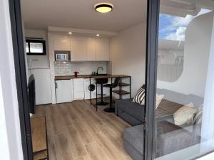 a small kitchen with a table and a counter at Dunasol 311 in Corralejo