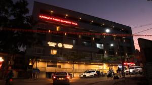 a building with cars parked in a parking lot at night at Narmada Residency in Hubli