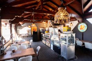 a restaurant with tables and chairs and a chandelier at Motel Delorean in Săcele