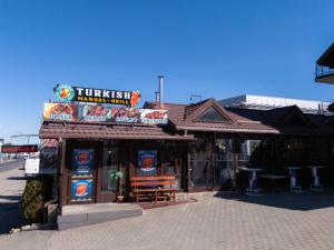 a fast food restaurant with a bench in front of it at Motel Delorean in Săcele