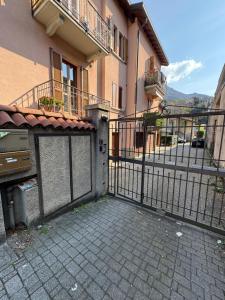 a gate in front of a building with a fence at Ca di baragett in Mandello del Lario