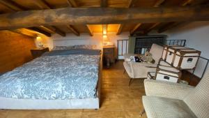 a bedroom with a bed and chairs in a room at Sicily Private Pool House in Nature in Montargano