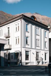 a white building on the side of a street at Tower Triple Suite - 3 min walk to Bernina Express in Tirano