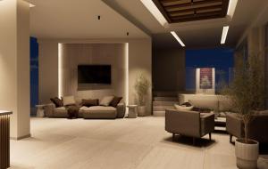 a living room with a couch and a tv at Ekavi Hotel in Sfakaki