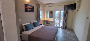 a bedroom with a large bed with blue pillows at Villa Kavourakia in Kolios