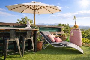 a table and two chairs with an umbrella on a yard at dream tiny house & luxury tent in Chania