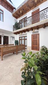 a large room with two benches and a balcony at Bukhara Baraka Boutique Hotel in Bukhara
