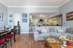 a living room with a couch and a table at Snowdonia View in Llanfairpwllgwyngyll