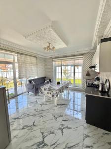 a large living room with a table and a couch at Gabala Luxury Nature Villa in Gabala