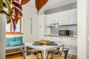 a kitchen and dining room with a table and chairs at Windshouse 2 Apartments in Nago-Torbole