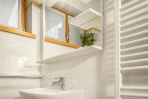 a bathroom with a sink and a mirror at Windshouse 2 Apartments in Nago-Torbole +26 photos