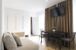 a living room with a table and a couch at Studia a apartmány U Karla in Turnov