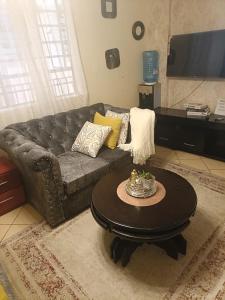 a living room with a couch and a coffee table at Soney Homes in Nairobi