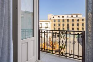 a balcony with a view of a building at Archimede Charm B&B - Historical Palace in Ortigia in Syracuse