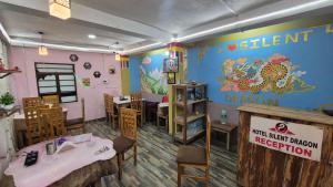 a restaurant with a dining room with a table and chairs at Rainbow Guest House in Sonāda