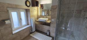 a bathroom with a shower and a sink and a window at Casa di Clara in Sulmona +22 photos