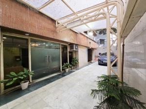 a building with a green door and some plants at Hotel Akashdeep in Kolkata
