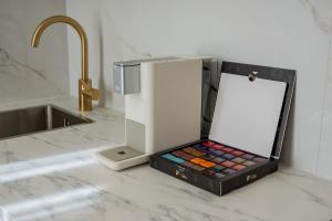 a box of cosmetics sitting on a counter next to a sink at Prenzlauer Berg Prestige in Berlin +19 photos