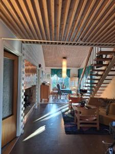 a living room with a staircase and a fireplace at Workers Stay - Construction Worker Göteborg in Gothenburg +1 photo