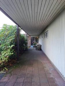 a walkway leading to a white building with a roof at Workers Stay - Construction Worker Göteborg in Gothenburg