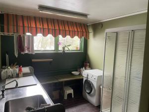 a kitchen with a sink and a washing machine at Workers Stay - Construction Worker Göteborg in Gothenburg