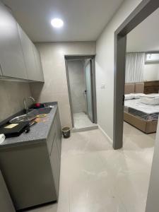 a kitchen with a sink and a bed in a room at سويتات الباديه in Dammam