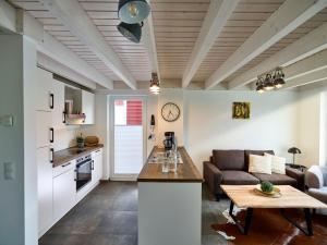 a kitchen and living room with a couch and a table at Ferienhaus Pier 85 in Nordhorn
