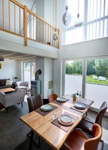 a dining room with a wooden table and chairs at Ferienhaus Pier 85 in Nordhorn +11 photos