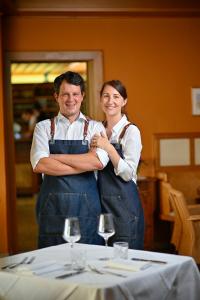 a man and a woman standing in front of a table at Maltschacher Seewirt in Feldkirchen in Kärnten