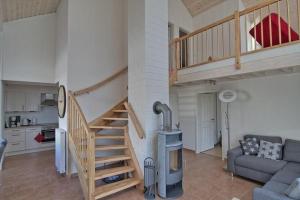 a living room with a staircase and a couch at Ferienhaus Luan in Nordhorn