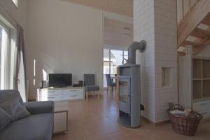 a living room with a fireplace with a couch and a table at Ferienhaus Luan in Nordhorn