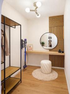a dressing room with a mirror and a stool at Suite Home Reichenhall in Bad Reichenhall