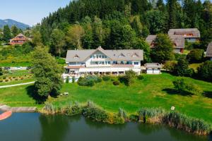 an aerial view of a large house on a lake at Maltschacher Seewirt in Feldkirchen in Kärnten
